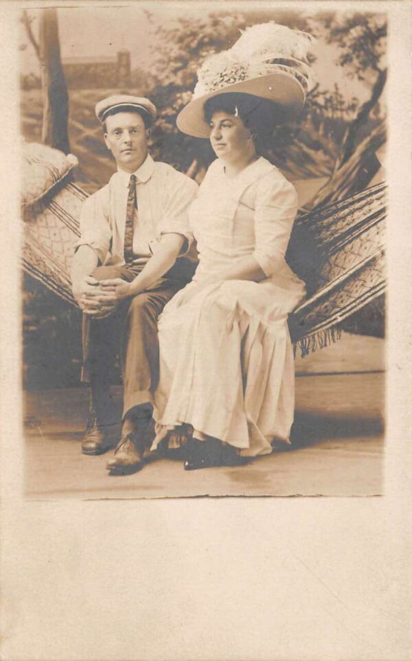 Lady and Man sitting in Hammock Studio Real Photo Vintage Postcard AA76130