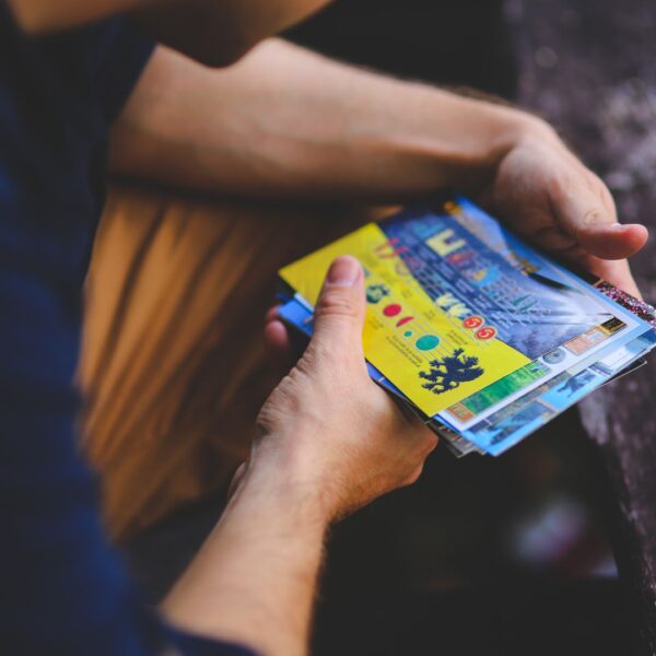 person holding postcards