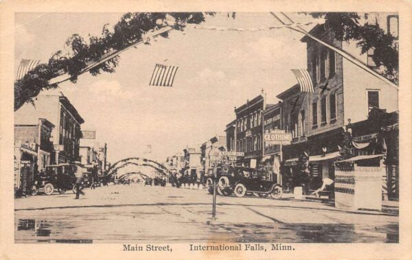 International Falls Minnesota Main Street Patriotic Decor Postcard AA92899